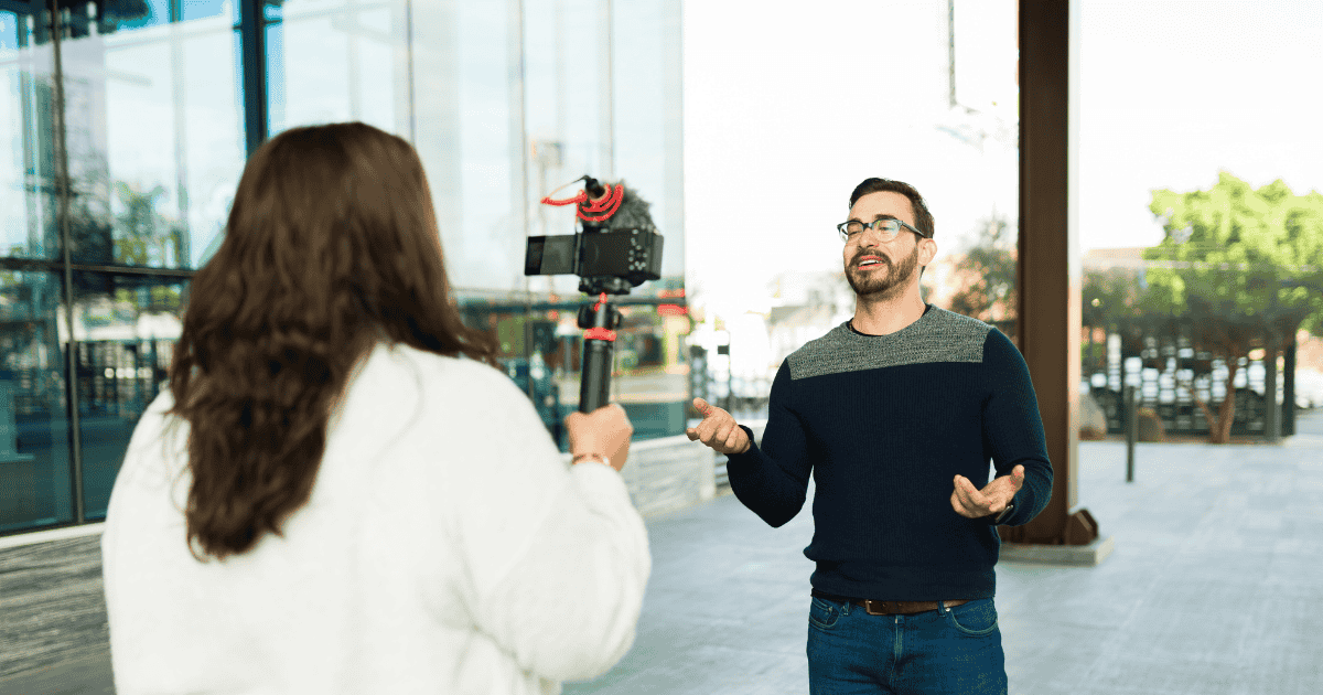 man being recorded with camera on street